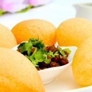 Round, hollow puri, fried crisp and filled with a mixture of water, tamarind, chili, chaat masala, potatoes, onions and chickpeas